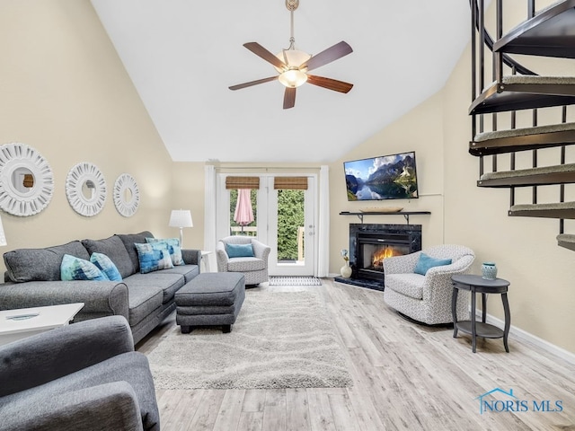 1104 Bernath Pkwy, Toledo, OH 43615 - living room featuring a ceiling fan, wood finished floors, a premium fireplace, baseboards, and high vaulted ceiling