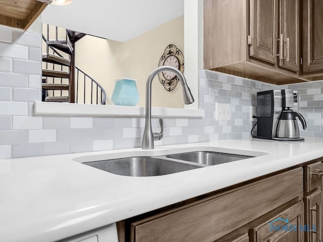 1104 Bernath Pkwy, Toledo, OH 43615 - kitchen with a sink, tasteful backsplash, and light countertops