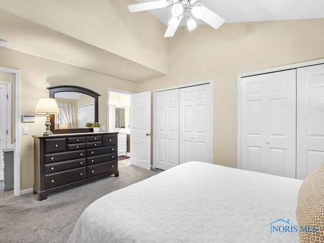 1104 Bernath Pkwy, Toledo, OH 43615 - bedroom with two closets, carpet, vaulted ceiling, baseboards, and a ceiling fan