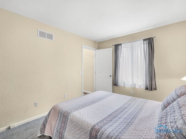1104 Bernath Pkwy, Toledo, OH 43615 - bedroom with a textured wall, carpet, and baseboards