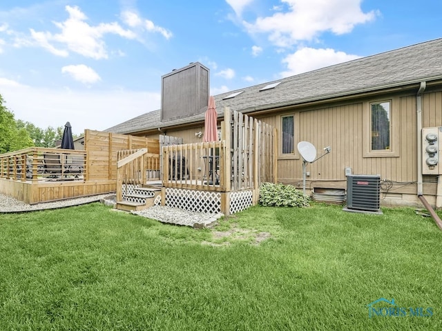 1104 Bernath Pkwy, Toledo, OH 43615 - rear view of house featuring a wooden deck, central AC unit, a yard, and roof with shingles