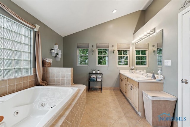 3127 Drummond Rd, Toledo, OH 43606 - full bathroom with vaulted ceiling, double vanity, a whirlpool tub, tile patterned floors, and baseboards