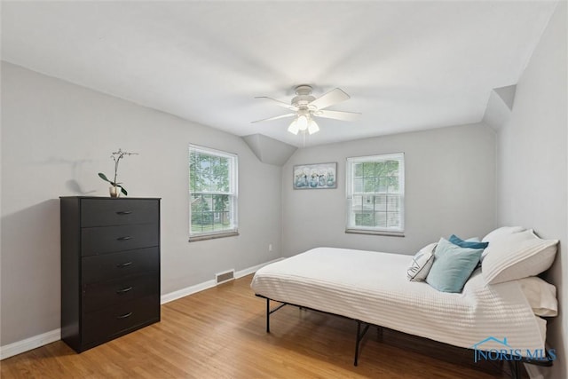 3127 Drummond Rd, Toledo, OH 43606 - bedroom with multiple windows, light wood finished floors, baseboards, and lofted ceiling