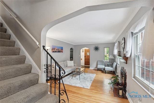 3127 Drummond Rd, Toledo, OH 43606 - entryway featuring arched walkways, stairs, ornamental molding, light wood-type flooring, and baseboards
