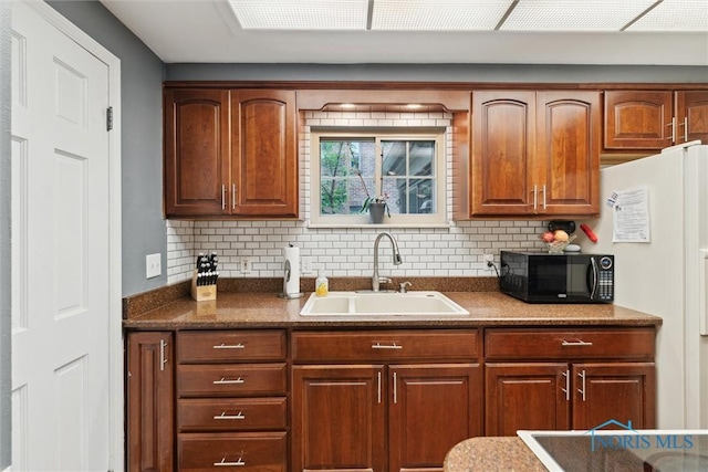3127 Drummond Rd, Toledo, OH 43606 - kitchen featuring black microwave, a sink, and backsplash