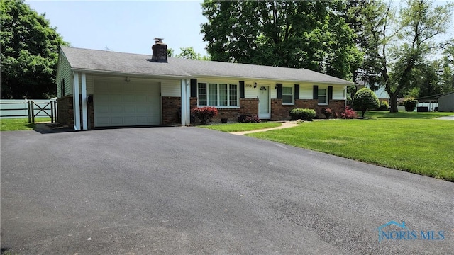 3713 Treelawn Dr, Toledo, OH 43614 - ranch-style house with an attached garage, brick siding, a chimney, and driveway