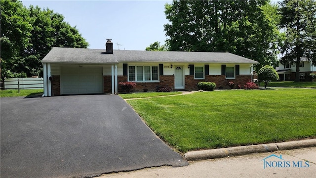 3713 Treelawn Dr, Toledo, OH 43614 - single story home featuring a garage, a chimney, driveway, and brick siding