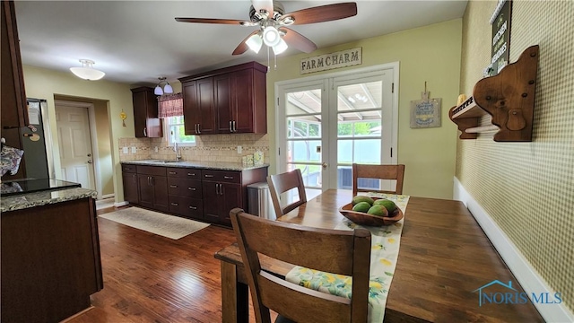 3713 Treelawn Dr, Toledo, OH 43614 - kitchen with dark wood-type flooring, a ceiling fan, decorative backsplash, light stone counters, and dark brown cabinetry