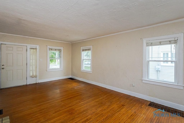 3819 Rushland Ave, Toledo, OH 43613 - empty room with hardwood / wood-style floors, crown molding, and a textured ceiling