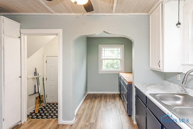 3819 Rushland Ave, Toledo, OH 43613 - kitchen featuring light countertops, light wood-type flooring, white cabinets, ceiling fan, and wooden ceiling