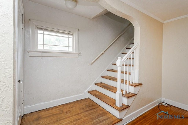 3819 Rushland Ave, Toledo, OH 43613 - staircase with wood finished floors, crown molding, and arched walkways