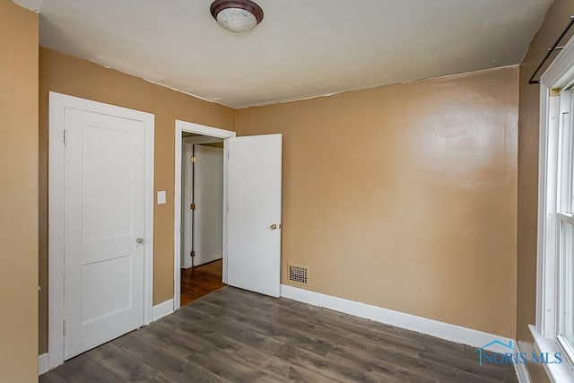 3819 Rushland Ave, Toledo, OH 43613 - unfurnished bedroom featuring dark wood-style flooring and baseboards