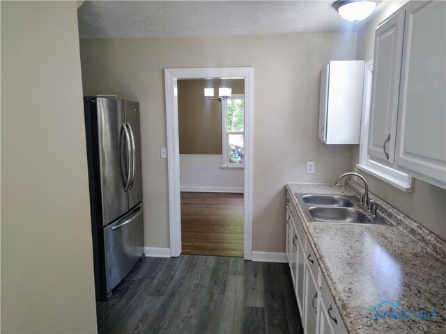 2417 Lambert Dr, Toledo, OH 43613 - kitchen featuring freestanding refrigerator, a sink, white cabinets, dark wood-style flooring, and baseboards