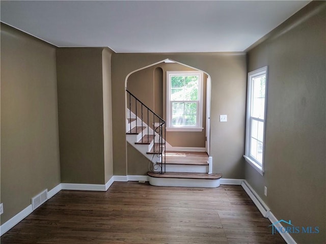 2417 Lambert Dr, Toledo, OH 43613 - stairs featuring plenty of natural light, wood finished floors, and arched walkways