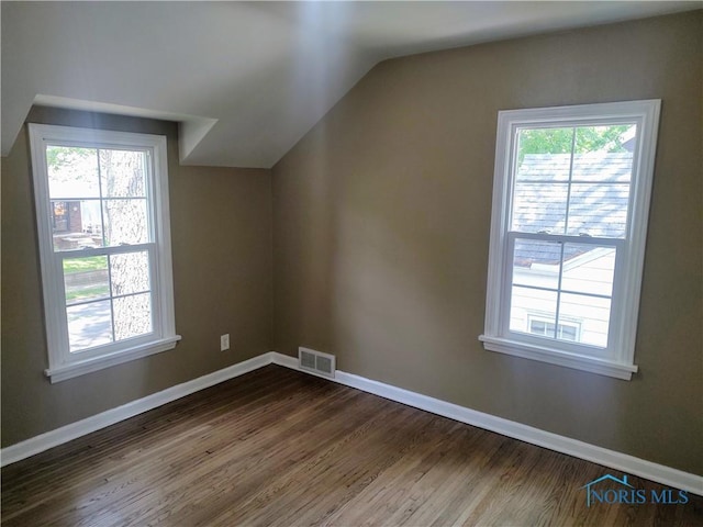 2417 Lambert Dr, Toledo, OH 43613 - additional living space featuring dark wood finished floors, vaulted ceiling, and baseboards