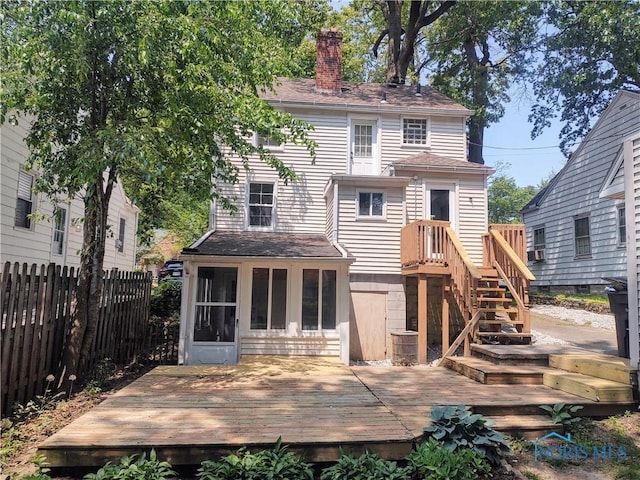 2417 Lambert Dr, Toledo, OH 43613 - back of property with a chimney, a sunroom, a wooden deck, and a shingled roof