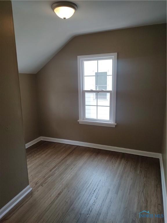 2417 Lambert Dr, Toledo, OH 43613 - additional living space with wood finished floors, lofted ceiling, and baseboards