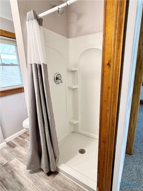1522 Nevada St, Toledo, OH 43605 - bathroom with a shower stall, toilet, baseboards, and wood finished floors
