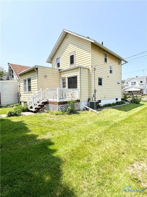 1522 Nevada St, Toledo, OH 43605 - back of house with a wooden deck, a lawn, and cooling unit