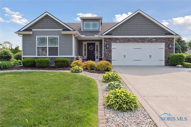 10 Hidden Village Ln, Holland, OH 43528 - craftsman house with stone siding, a front lawn, an attached garage, and concrete driveway