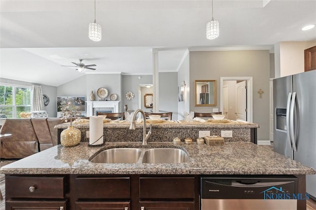 10 Hidden Village Ln, Holland, OH 43528 - kitchen featuring appliances with stainless steel finishes, open floor plan, a center island with sink, ceiling fan, and dark brown cabinetry
