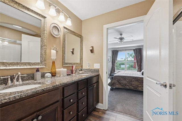 10 Hidden Village Ln, Holland, OH 43528 - ensuite bathroom featuring double vanity, ceiling fan, and wood finished floors