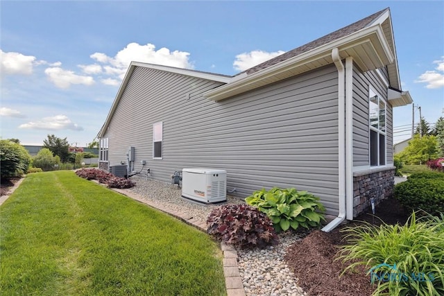 10 Hidden Village Ln, Holland, OH 43528 - view of side of property with a lawn and stone siding