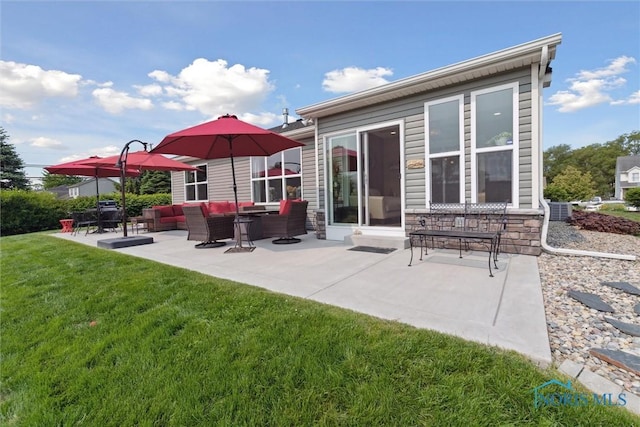 10 Hidden Village Ln, Holland, OH 43528 - back of house with a lawn, a patio area, stone siding, and an outdoor hangout area