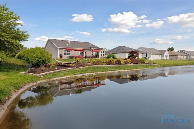 10 Hidden Village Ln, Holland, OH 43528 - rear view of property featuring a residential view, a water view, and a lawn