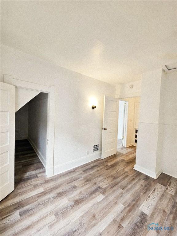 630 Highland Ave, Toledo, OH 43610 - empty room featuring wood finished floors and baseboards