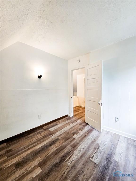 630 Highland Ave, Toledo, OH 43610 - unfurnished room with wood finished floors, a textured ceiling, and baseboards
