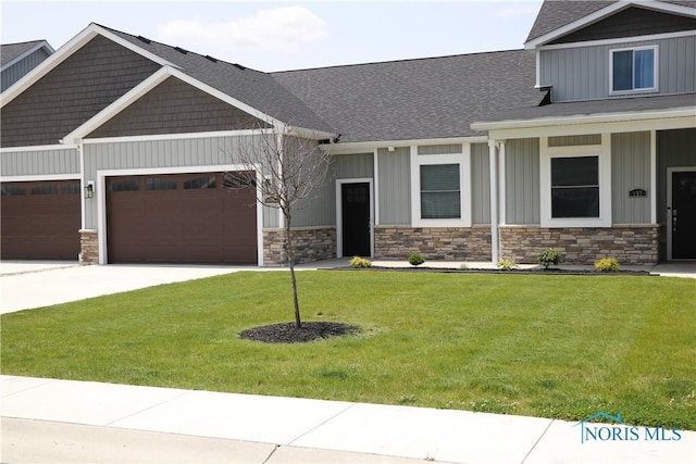 199 E Bridge Rd, Northwood, OH 43619 - craftsman-style home featuring a garage, board and batten siding, stone siding, and concrete driveway