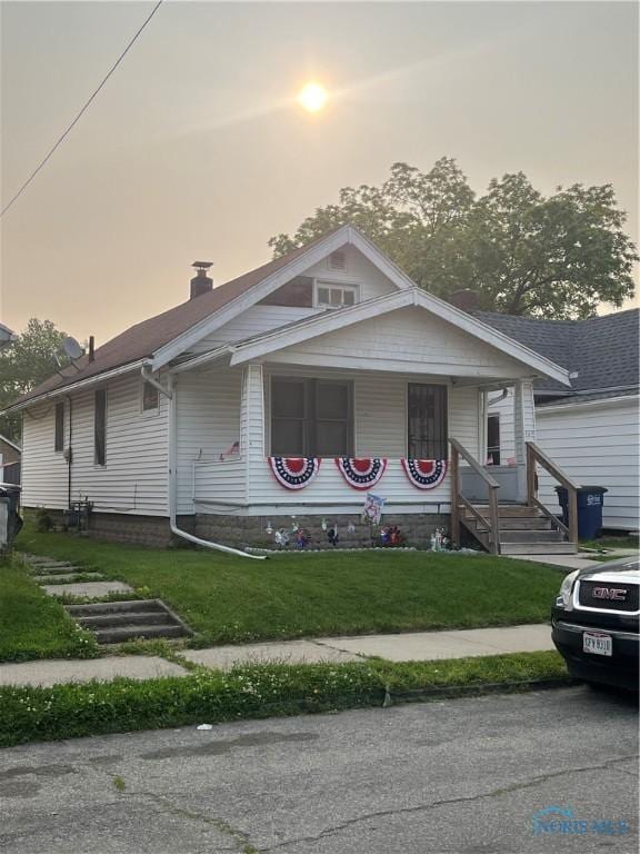 267 Licking St, Toledo, OH 43605 - bungalow-style house with a chimney, a front yard, and a porch