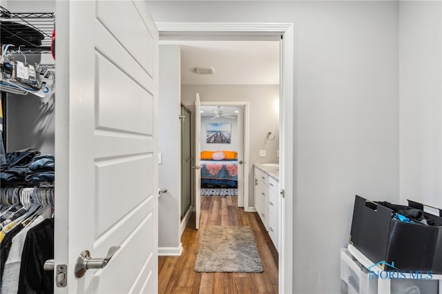 1313 Washington Ave, Findlay, OH 45840 - ensuite bathroom with wood finished floors, a ceiling fan, a stall shower, vanity, and a walk in closet