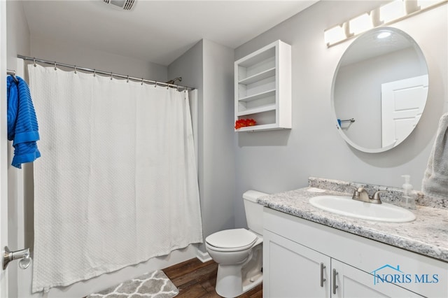 1313 Washington Ave, Findlay, OH 45840 - bathroom with wood finished floors, vanity, toilet, and shower / bath combo with shower curtain