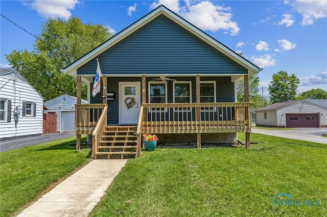 1313 Washington Ave, Findlay, OH 45840 - bungalow-style home with a porch, a front lawn, and a garage