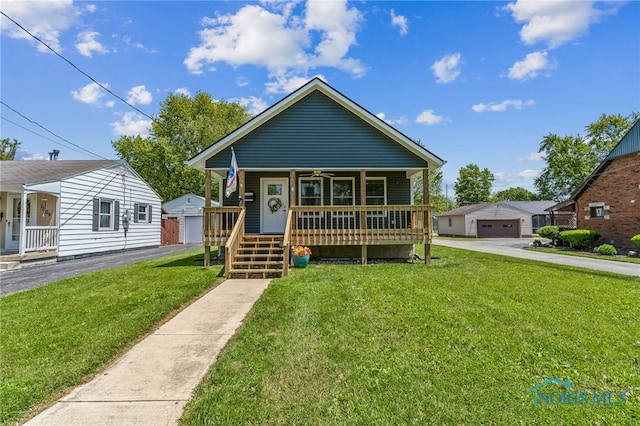 1313 Washington Ave, Findlay, OH 45840 - bungalow with covered porch, a front lawn, and a garage