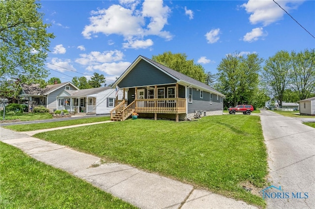 1313 Washington Ave, Findlay, OH 45840 - view of front of house with a porch, a front yard, and driveway