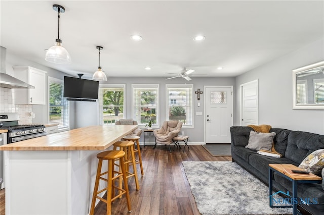 1313 Washington Ave, Findlay, OH 45840 - kitchen featuring wood counters, gas stove, open floor plan, white cabinetry, and a kitchen breakfast bar