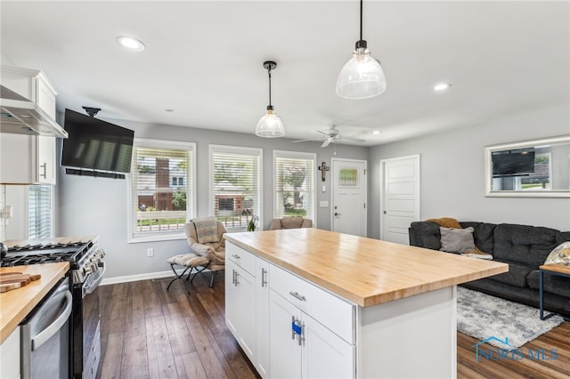 1313 Washington Ave, Findlay, OH 45840 - kitchen with wood counters, open floor plan, wall chimney exhaust hood, white cabinetry, and recessed lighting