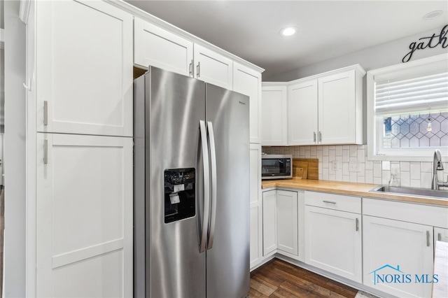1313 Washington Ave, Findlay, OH 45840 - kitchen with appliances with stainless steel finishes, a sink, butcher block countertops, white cabinets, and tasteful backsplash