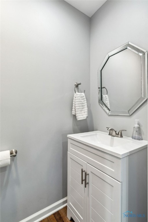 1313 Washington Ave, Findlay, OH 45840 - bathroom with vanity, wood finished floors, and baseboards
