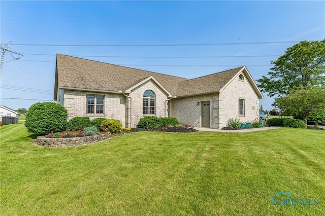3112 Jacob Dr, Findlay, OH 45840 - ranch-style home featuring brick siding, roof with shingles, and a front yard