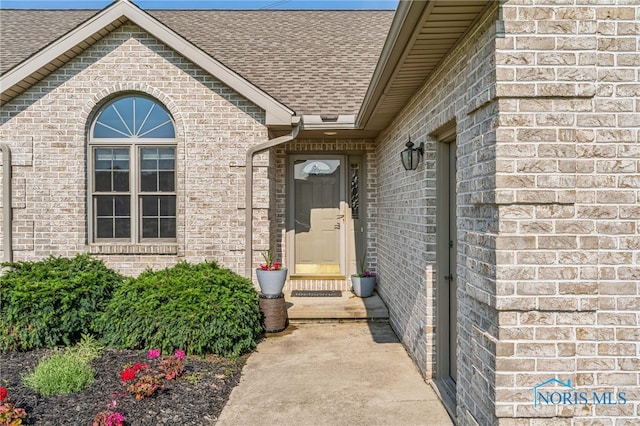 3112 Jacob Dr, Findlay, OH 45840 - doorway to property with roof with shingles and brick siding