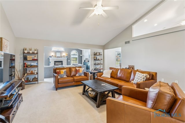 3112 Jacob Dr, Findlay, OH 45840 - living area featuring ceiling fan, light carpet, a glass covered fireplace, and high vaulted ceiling