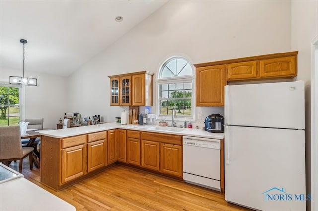 3112 Jacob Dr, Findlay, OH 45840 - kitchen with white appliances, a peninsula, a sink, light wood-type flooring, and light countertops