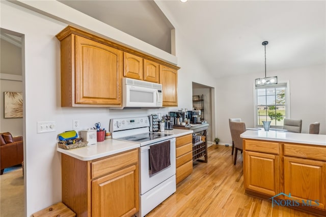 3112 Jacob Dr, Findlay, OH 45840 - kitchen with white appliances, lofted ceiling, light countertops, light wood-type flooring, and a chandelier