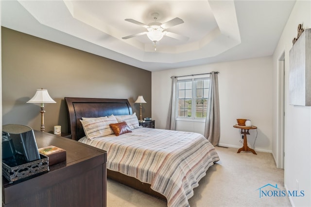 3112 Jacob Dr, Findlay, OH 45840 - bedroom with a tray ceiling, light carpet, baseboards, and ceiling fan