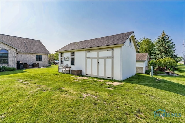 3112 Jacob Dr, Findlay, OH 45840 - rear view of property featuring a lawn and a shingled roof
