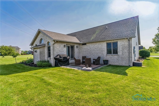 3112 Jacob Dr, Findlay, OH 45840 - rear view of house featuring brick siding, a shingled roof, a yard, and a patio